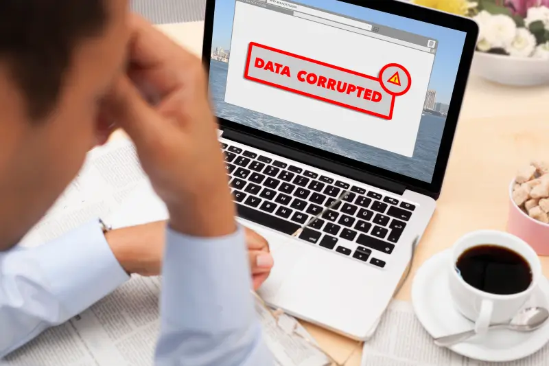 Businessman stressed about data loss after getting an error message on laptop.
