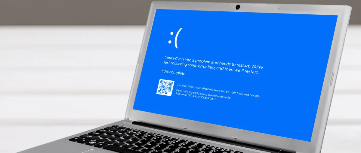 A blue screen of death display with an error message that Windows must restart.