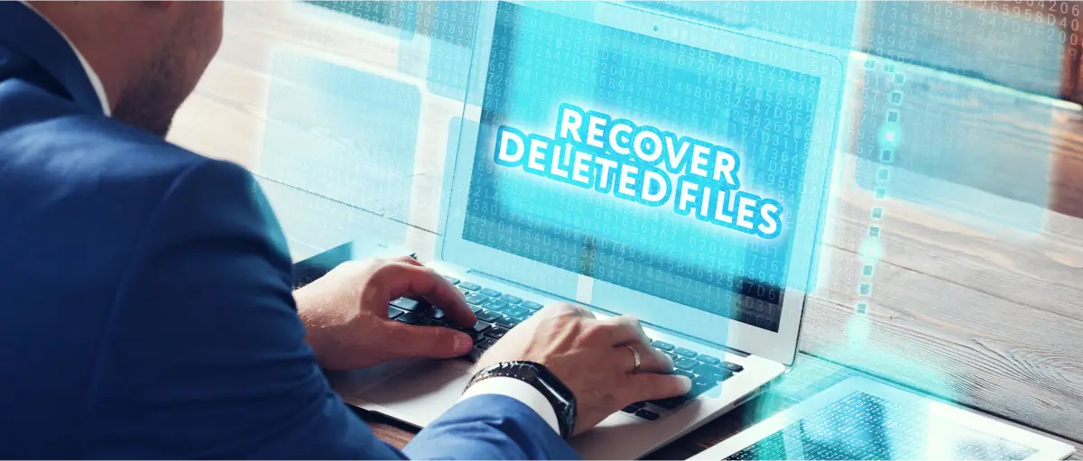 A concept of a businessman recovering deleted files on a laptop.