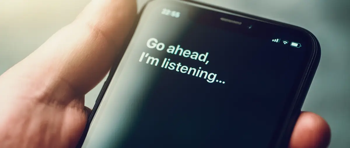 An image of a smartphone with the text Go ahead, I’m listening… on the screen.