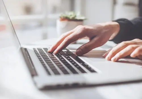 Man typing on laptop