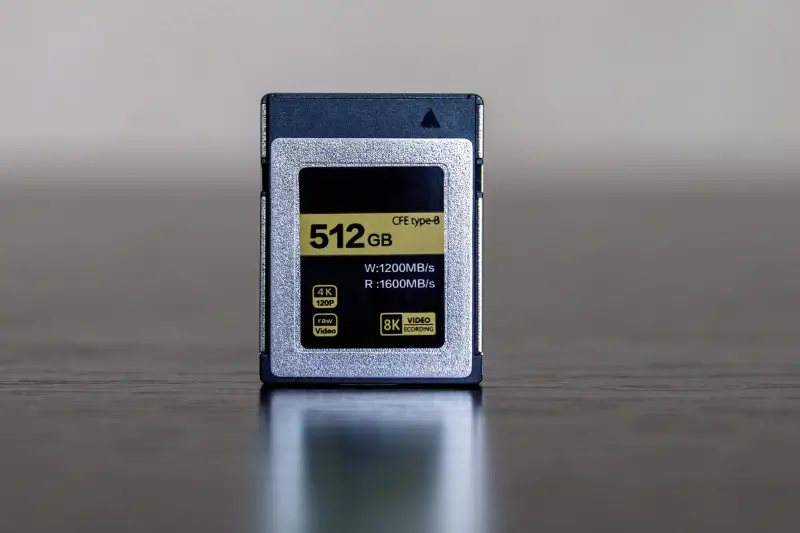 A CFexpress memory card on a dark table.