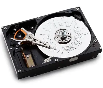 An overhead view of a damaged hard drive with scratched platters.