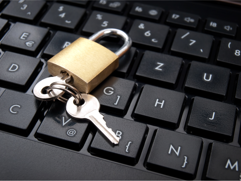 A lock and key on a keyboard, representing an encrypted computer.