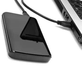 An image of an external hard drive plugged into a laptop.