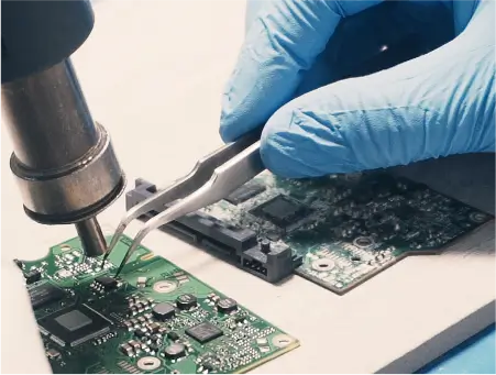 An engineer working on a hard drive’s PCB.