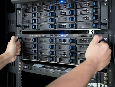 An image of a technician handling hard drives within a server.