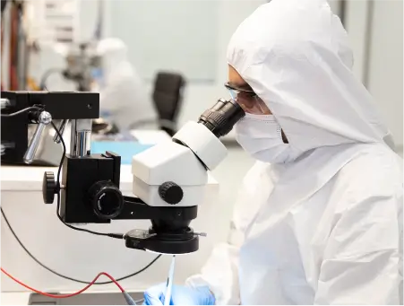 An image of an engineer using tools to diagnose and repair a damaged hard drive.